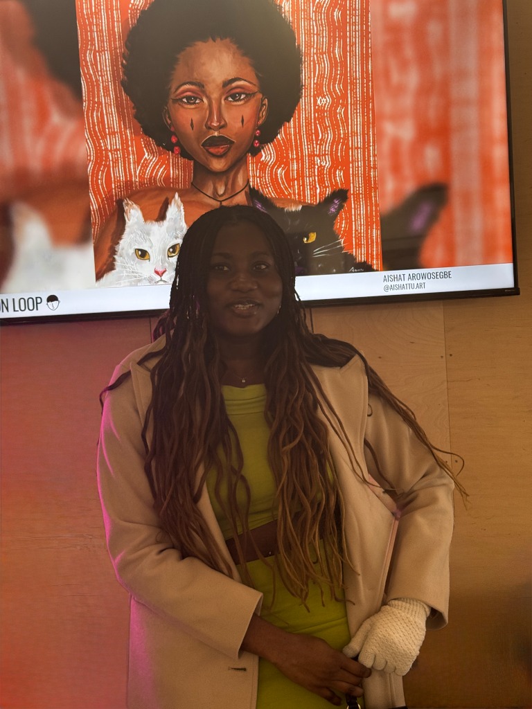 Aishat Arowosegbe with her artwork at The Holy Art Gallery